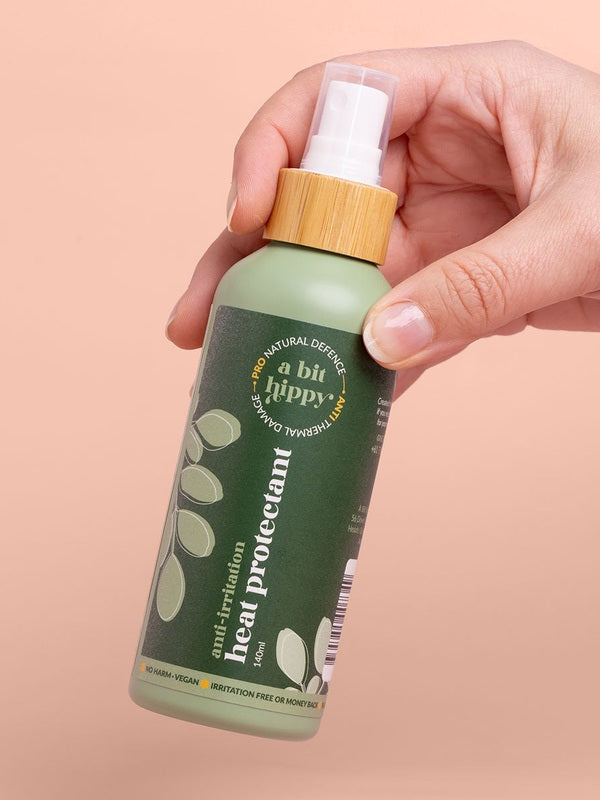 A bit Hippy Heat Protectant Spray held in hand
