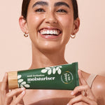 A bit Hippy Face and Body Moisturiser held by a smiling woman