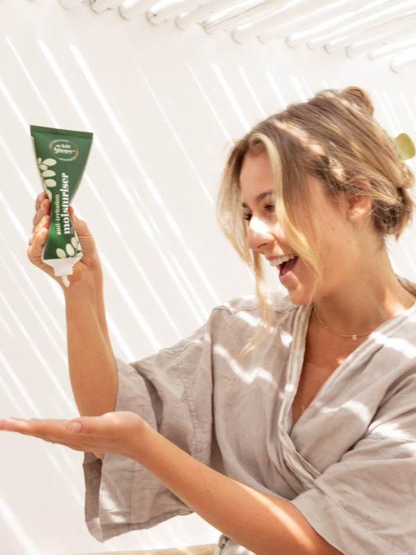 A bit Hippy Face and Body Moisturiser held during a self-care routine