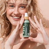 A bit Hippy Oil Cleanser held by a smiling woman