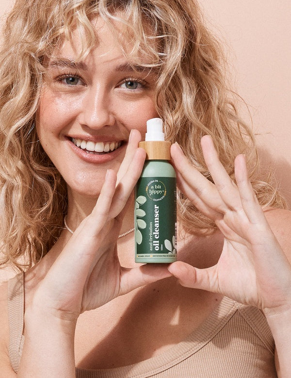 A bit Hippy Oil Cleanser held by a smiling woman