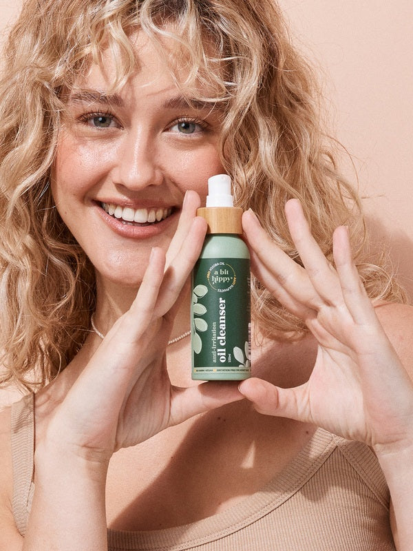 A bit Hippy Oil Cleanser held by a smiling woman