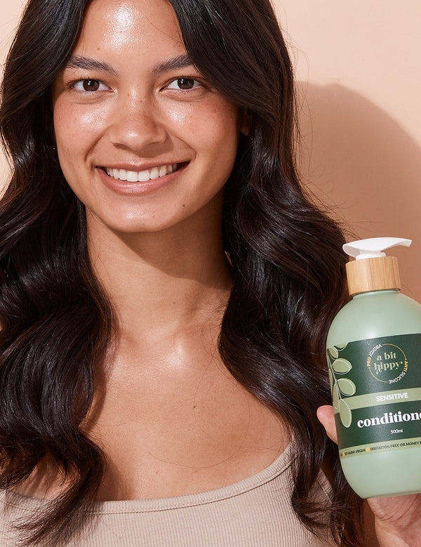 A bit Hippy Sensitive Conditioner held by a smiling woman