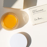 Ere Perez Papaya SOS Marmalade open jar with lid and boxes on a cream background