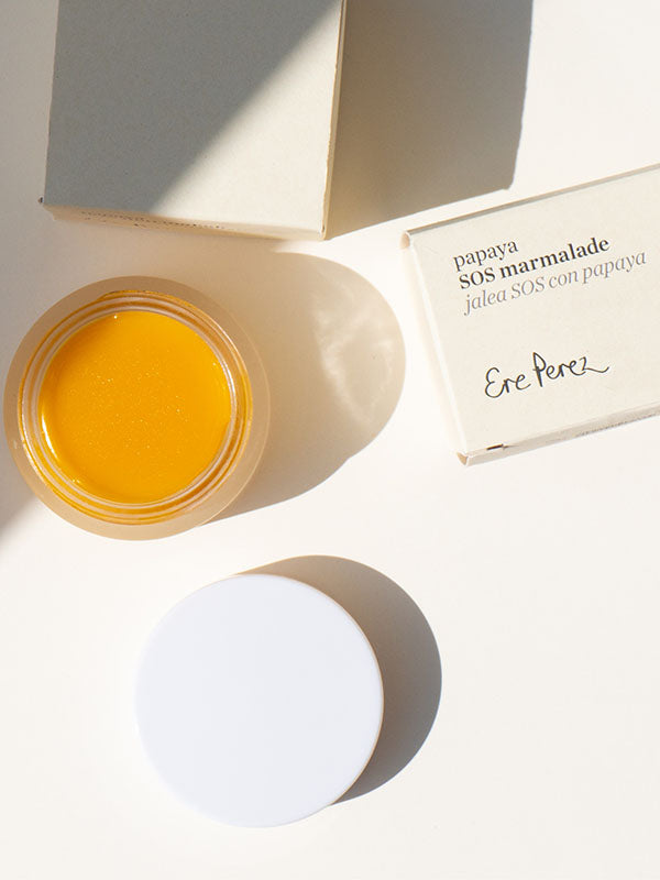 Ere Perez Papaya SOS Marmalade open jar with lid and boxes on a cream background