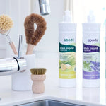 Abode Dishwashing Liquid Ginger and Lemongrass beside a kitchen sink