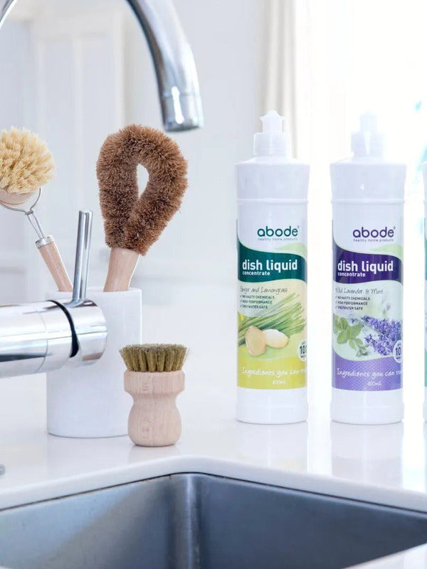 Abode Dishwashing Liquid Ginger and Lemongrass beside a kitchen sink