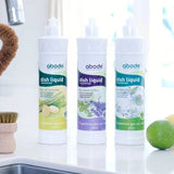 Abode Dishwashing Liquid Lime Spritz beside a kitchen sink