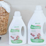 Abode Laundry Liquid Baby with folded towels in a laundry setting