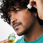 Man applying ACURE Radically Rejuvenating Bakuchiol Serum to his face