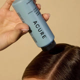 Model applying ACURE Dry Shampoo for All Hair Types