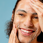 Man cleansing his face with ACURE Resurfacing Glycolic Cleanser