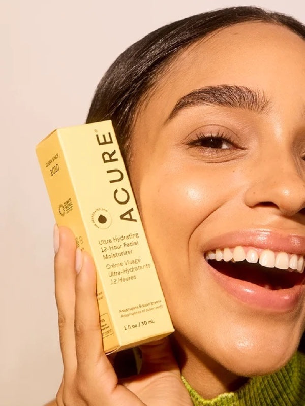 Model holding ACURE Ultra Hydrating 12 Hour Facial Moisturizer beside her face