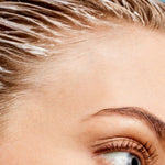 Close-up of ACURE Vivacious Volume Shampoo worked through wet hair