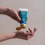 Herbs of Gold Magnesium Muscle Cream being applied to the hand