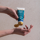 Herbs of Gold Magnesium Muscle Cream being applied to the hand