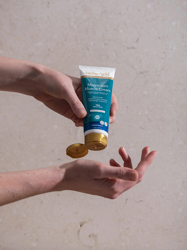 Herbs of Gold Magnesium Muscle Cream being applied to the hand