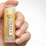 Hand holding Hurraw! Organic Lip Balm - Almond 4.8g