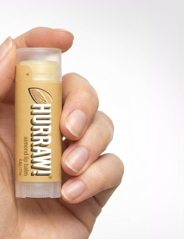 Hand holding Hurraw! Organic Lip Balm - Almond 4.8g