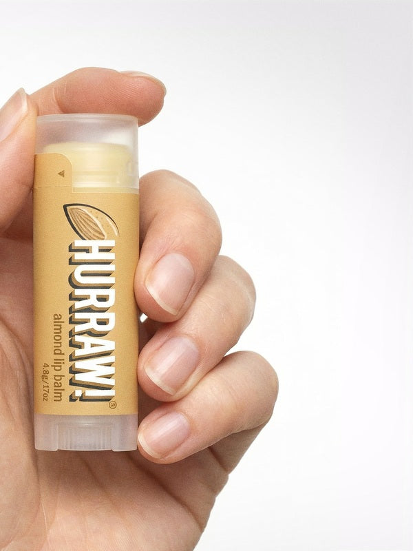 Hand holding Hurraw! Organic Lip Balm - Almond 4.8g