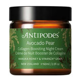 Antipodes Avocado Pear Night Cream in an amber glass jar with a green label, gold botanical details and a wide, smooth black lid, on white.