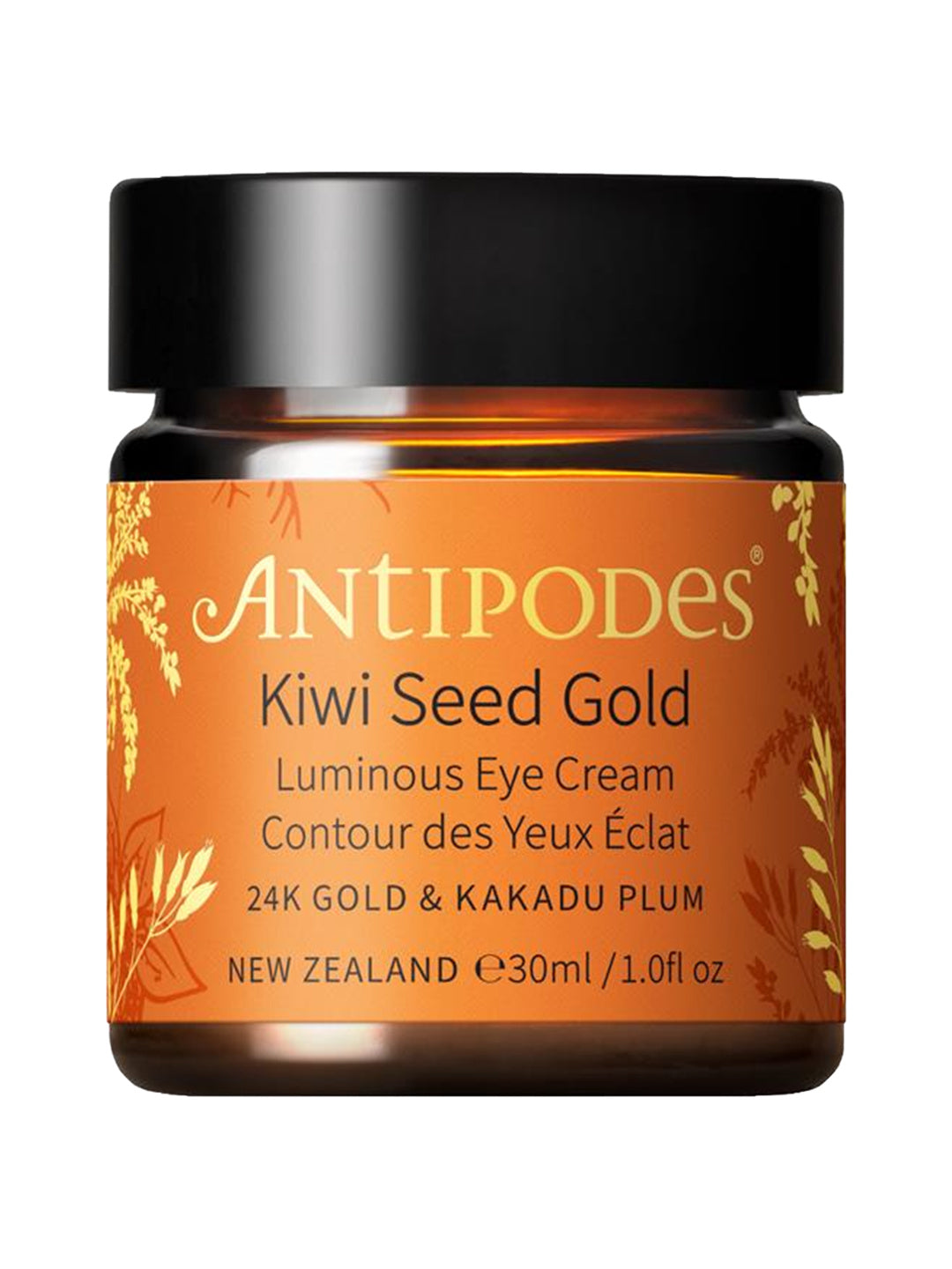 Antipodes Kiwi Seed Gold Luminous Eye Cream in an amber glass jar with an orange and gold botanical label and a wide black lid, on white.