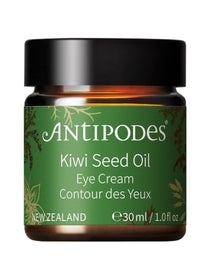Antipodes Kiwi Seed Oil Eye Cream in an amber glass jar with a green label, gold botanical details and a wide black lid, on white.