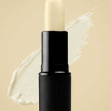 A tube of Antipodes Kiwi Seed Oil Lip Conditioner 4g in a black casing is shown against a beige background, with a smear of the nourishing lip balm behind it.
