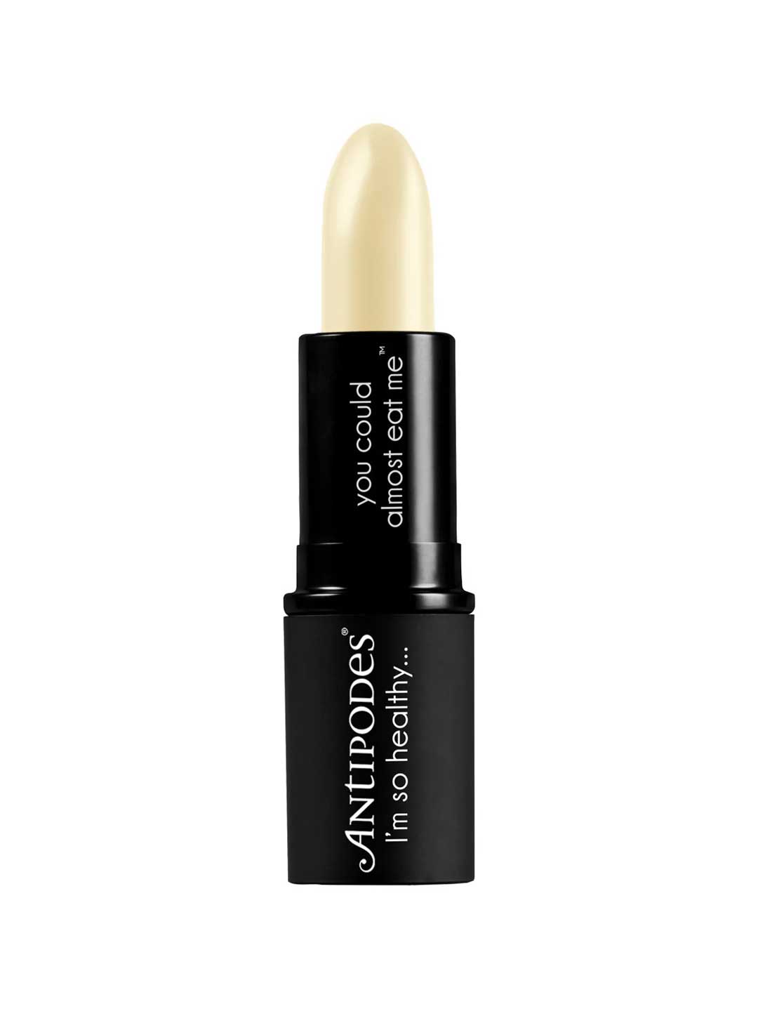 A 4g tube of Antipodes Kiwi Seed Oil Lip Conditioner features a creamy, pale yellow balm in a sleek black case with "you could almost eat me" and "ANTIPODES I’m so healthy…" printed on the packaging.