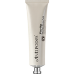Antipodes Purity Glass Skin Facial Polish in a pale silver squeeze tube with vertical black lettering and a small silver cap, standing on white.