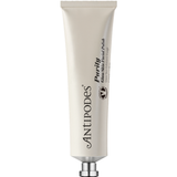 Antipodes Purity Glass Skin Facial Polish in a pale silver squeeze tube with vertical black lettering and a small silver cap, standing on white.
