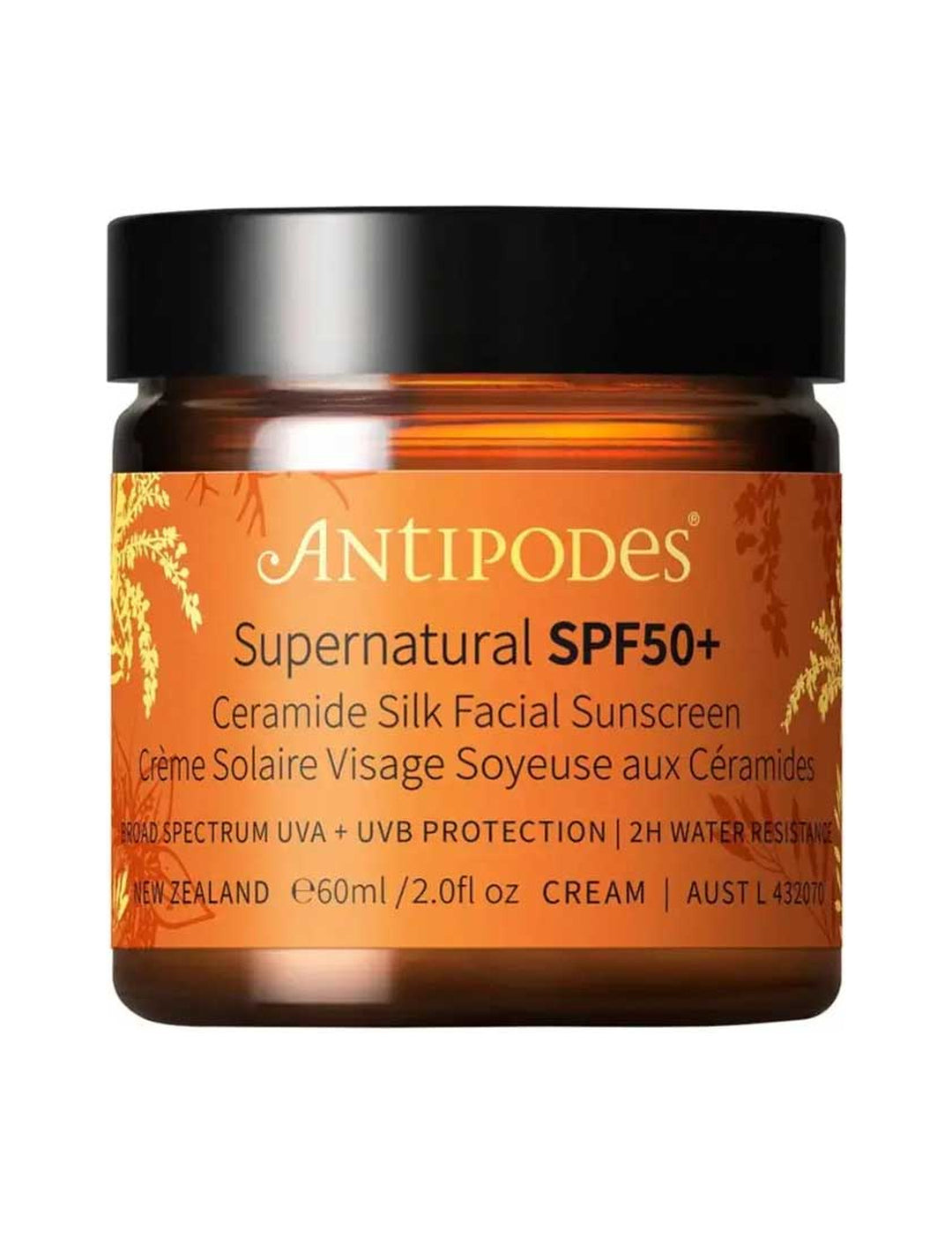 Antipodes Supernatural SPF50+ Ceramide Silk Facial Sunscreen in an amber glass jar with an orange and gold botanical label and a wide black lid.