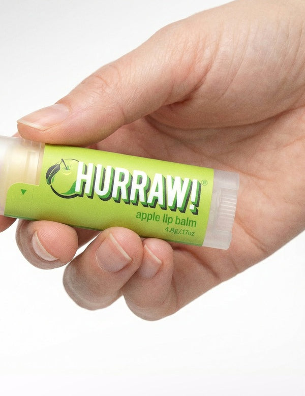 Hand holding Hurraw! Organic Lip Balm - Apple 4.8g