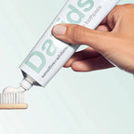 Davids Sensitive and Whitening Peppermint Toothpaste applied to a bamboo toothbrush