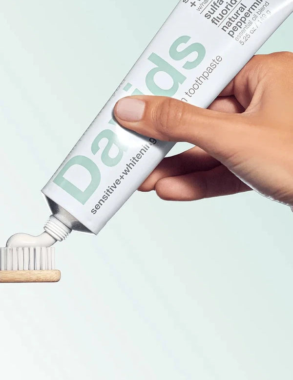 Davids Sensitive and Whitening Peppermint Toothpaste applied to a bamboo toothbrush