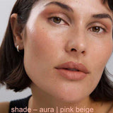 Close-up of a person wearing pink beige makeup with 'shade - aura | pink beige' text.