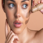 Model applying Avocado Zinc SPF 50 Natural Bronzer in Medium-Dark