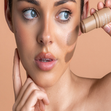 Model applying Avocado Zinc SPF 50 Natural Bronzer in Medium-Dark