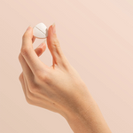 Hand holding a Herbs of Gold Magnesium Chewable raspberry tablet