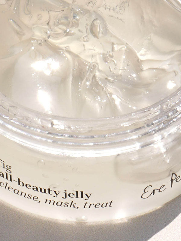 Close-up of the clear jelly texture inside the open Ere Perez Fig All-Beauty Jelly jar