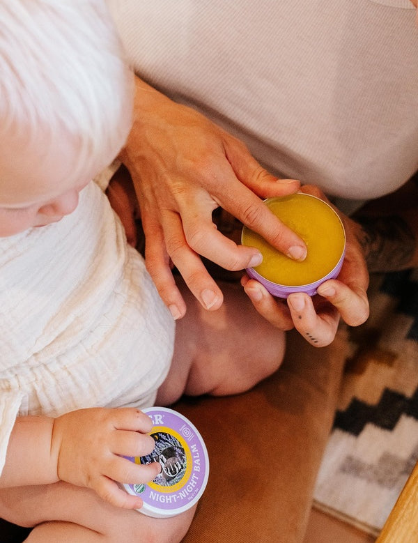 Parent using Badger Night-Night Balm with a child