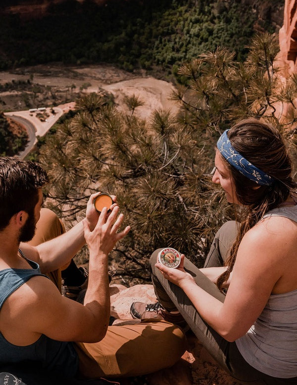 Hikers using Badger Sore Muscle Rub outdoors