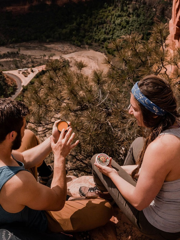 Hikers using Badger Sore Muscle Rub outdoors