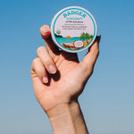 Badger Coconut After Sun Balm held at the beach