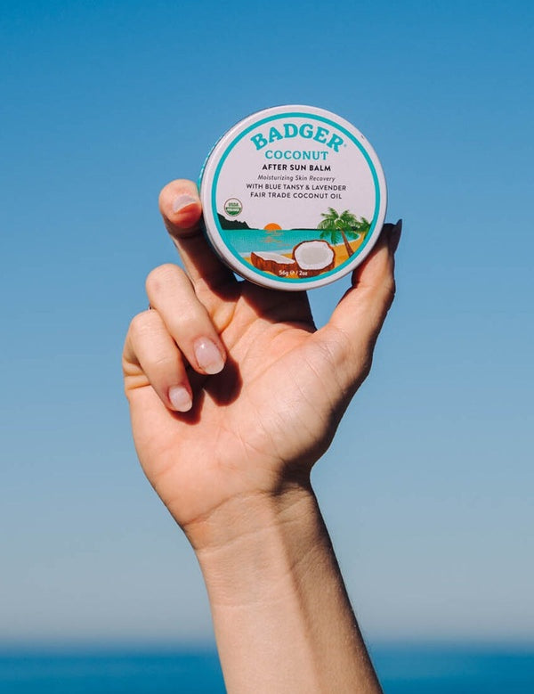 Badger Coconut After Sun Balm held at the beach