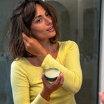 Woman styling her hair with Badger Hair Pomade