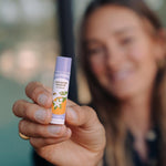 Badger Lavender and Orange Lip Balm held in hand