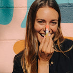 Woman applying Badger Pink Grapefruit Lip Balm