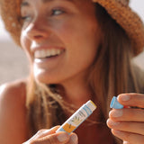 Woman holding Badger Unscented Lip Balm
