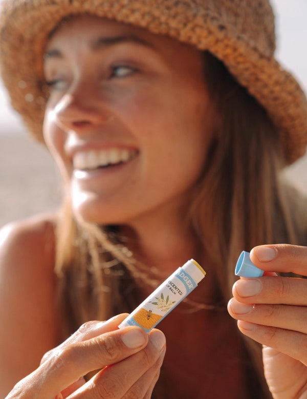 Woman holding Badger Unscented Lip Balm